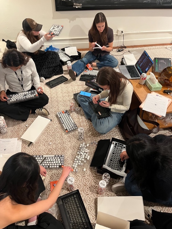 friends building mechanical keyboards on the floor