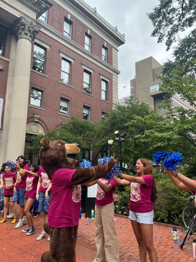 Barnard bear mascot with pom-poms on campus
